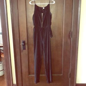Black jumpsuit with gold zipper